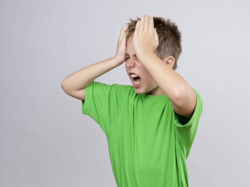 ill-little-boy-green-t-shirt-feeling-unwell-having-strong-headache-touching-head-standing-white-wall-min ill-little-boy-green-t-shirt-feeling-unwell-having-strong-headache-touching-head-standing-white-wall-min