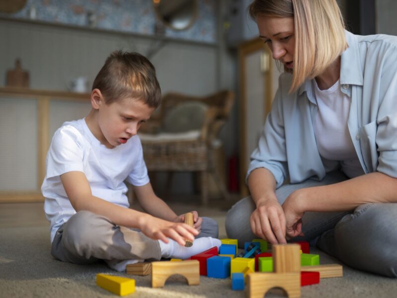 mother-playing-with-her-autistic-son-using-toys-min mother-playing-with-her-autistic-son-using-toys-min